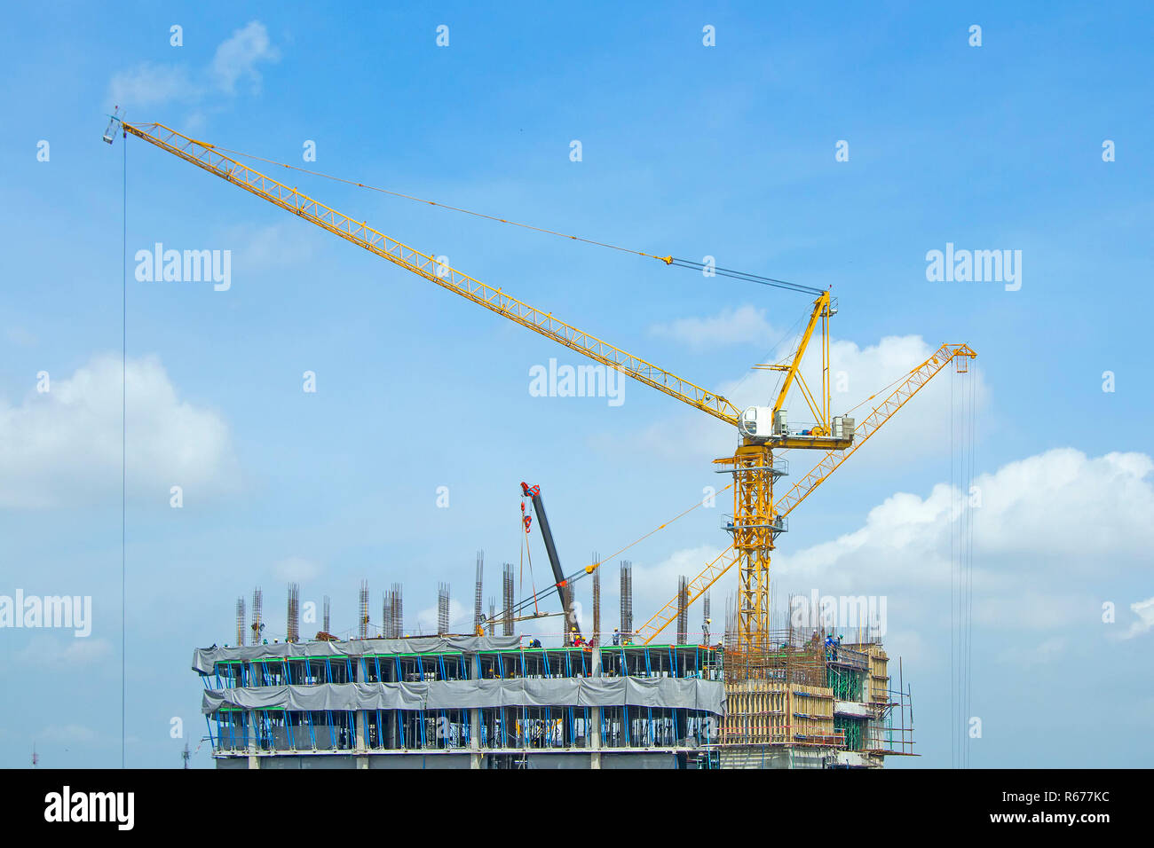 Crane lifts building with construction workers Stock Photo Alamy