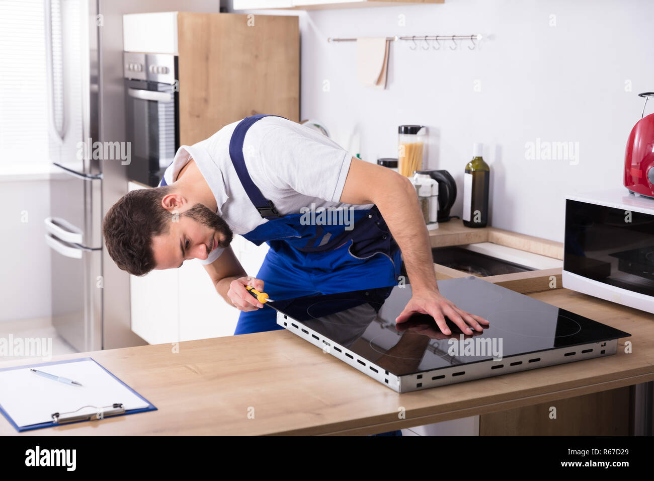 Electrician Fixing Induction Stove Stock Photo Alamy