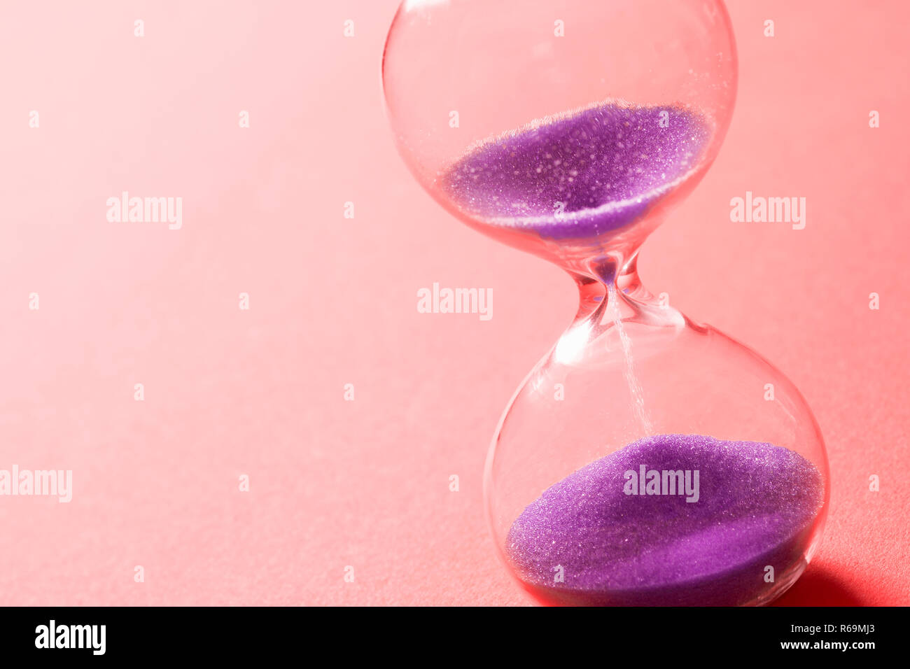 purple sand clock hourglass Stock Photo Alamy