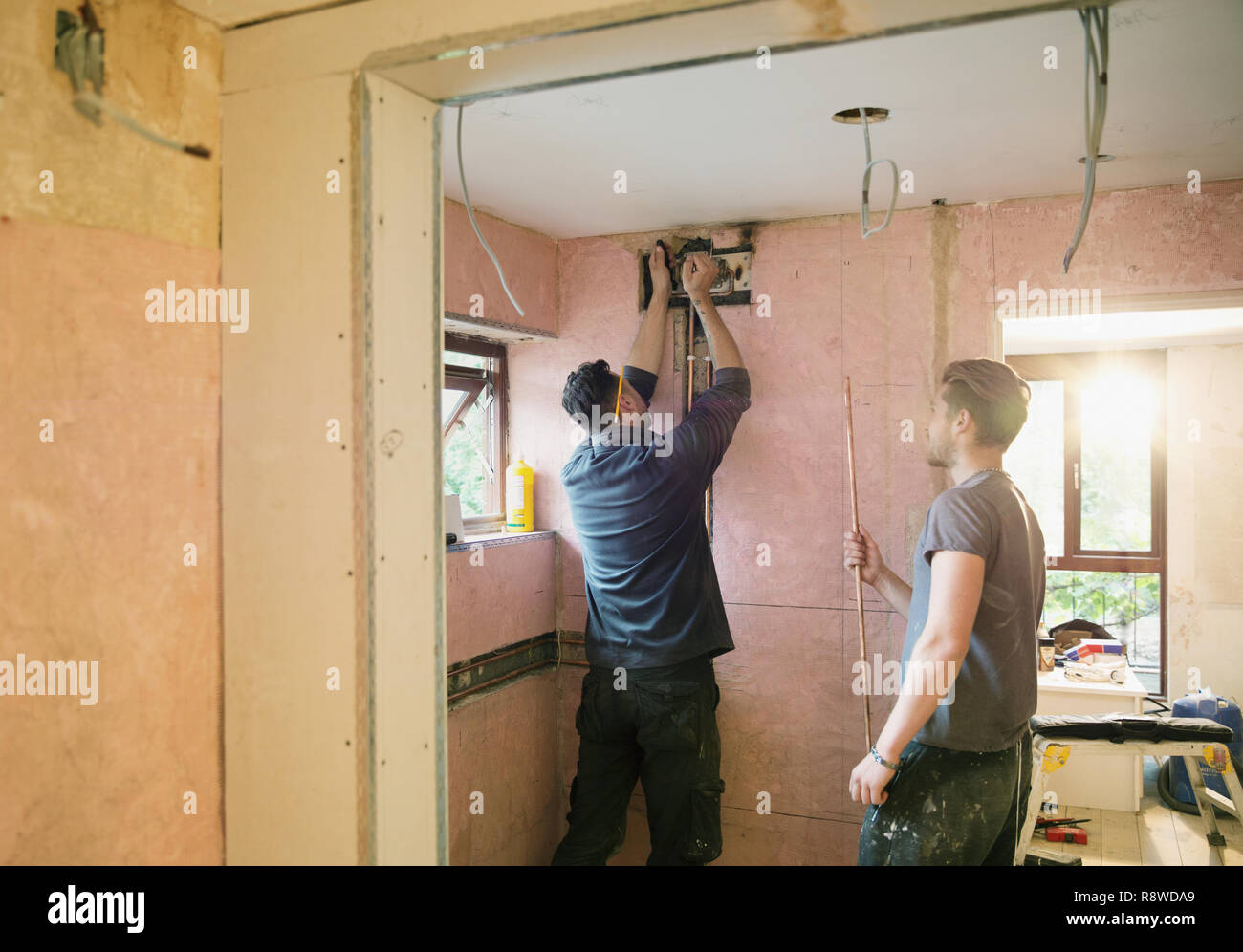 Construction workers installing copper pipe in house Stock Photo Alamy