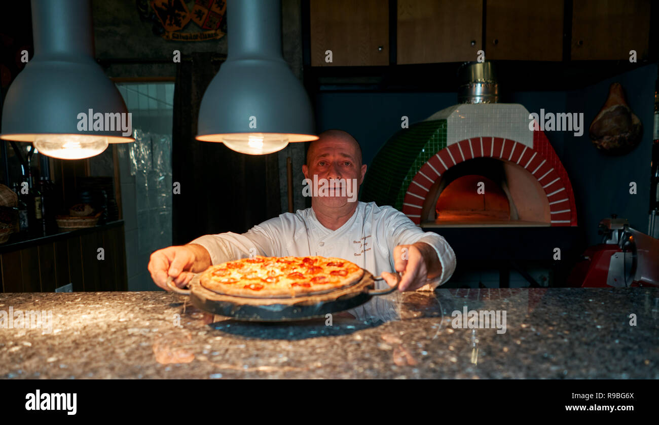cook throws the pizza Stock Photo Alamy