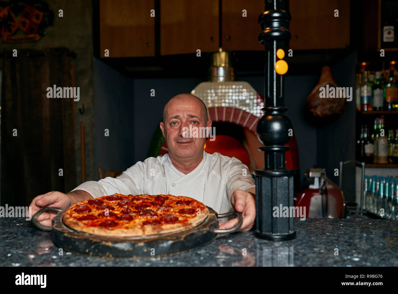 cook throws the pizza Stock Photo Alamy