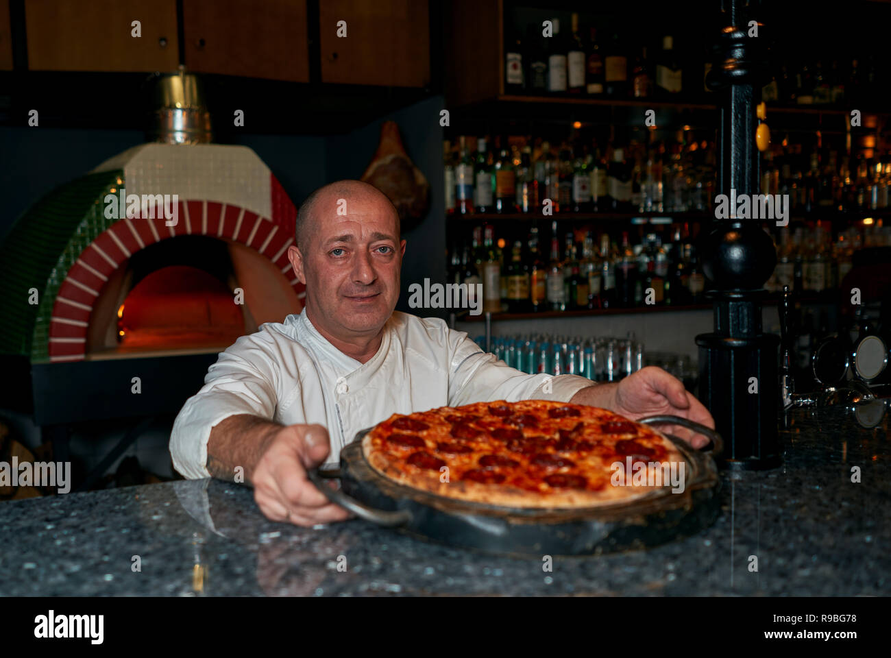 cook throws the pizza Stock Photo Alamy