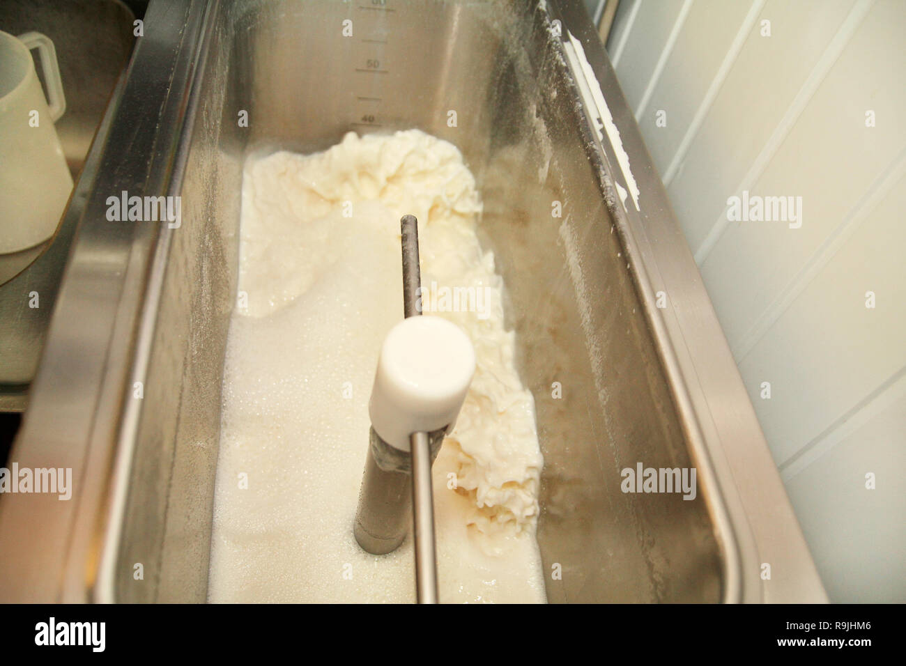 Ice cream making process at ice cream factory, milk and cooking mixing