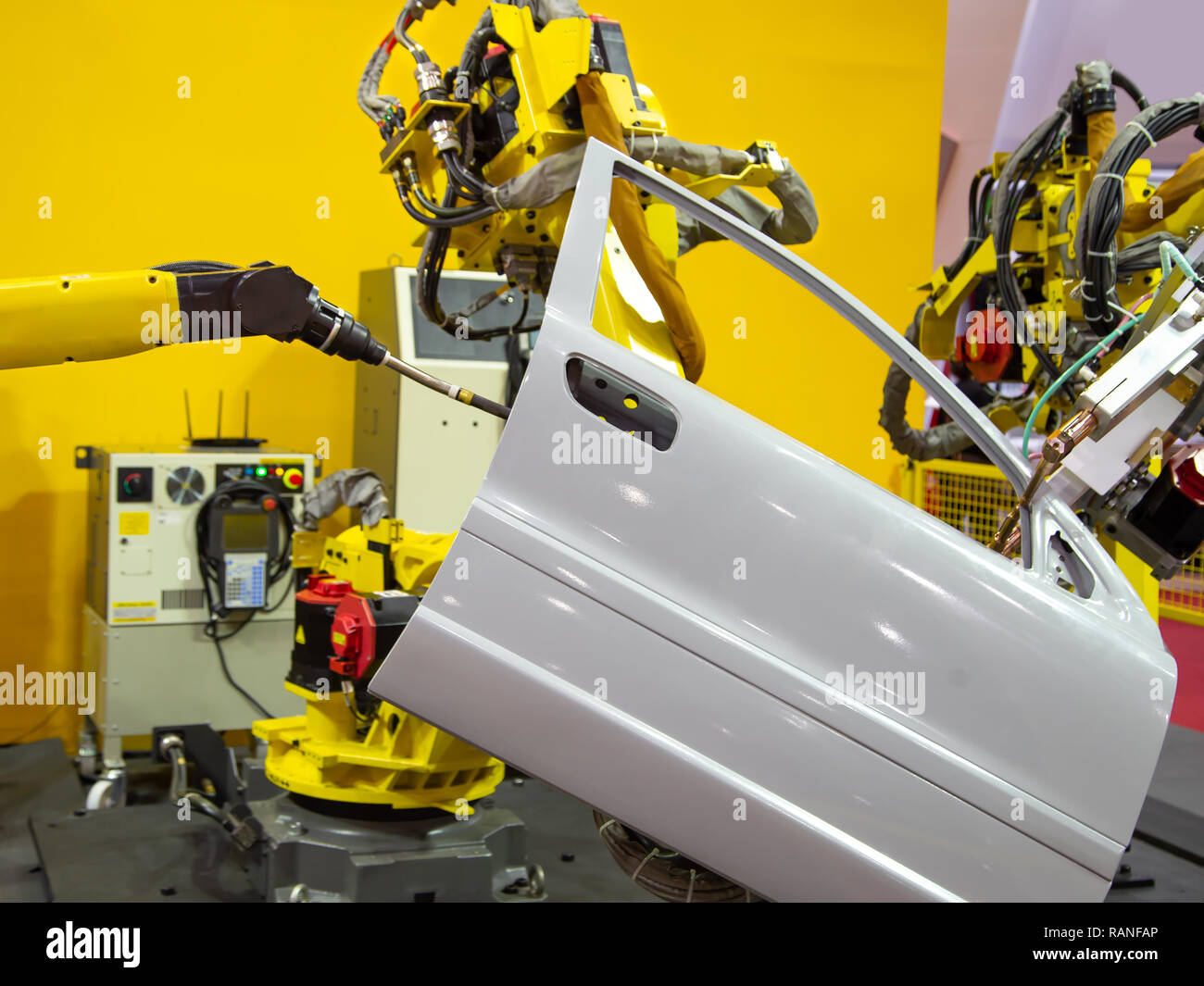 Robot arm demonstrate spot welding car door Stock Photo Alamy