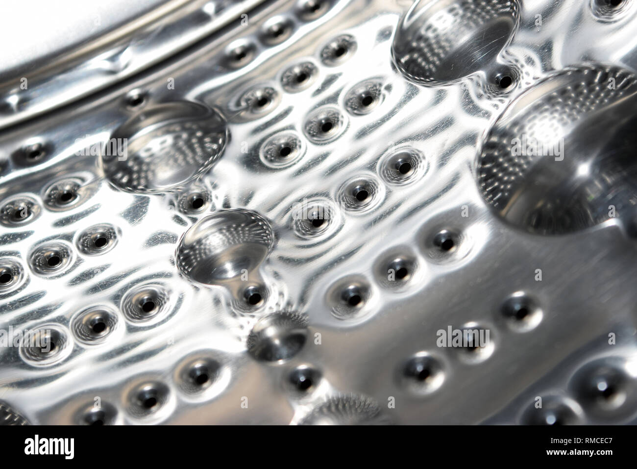 Washing machine inside and bubbles on metal Stock Photo Alamy