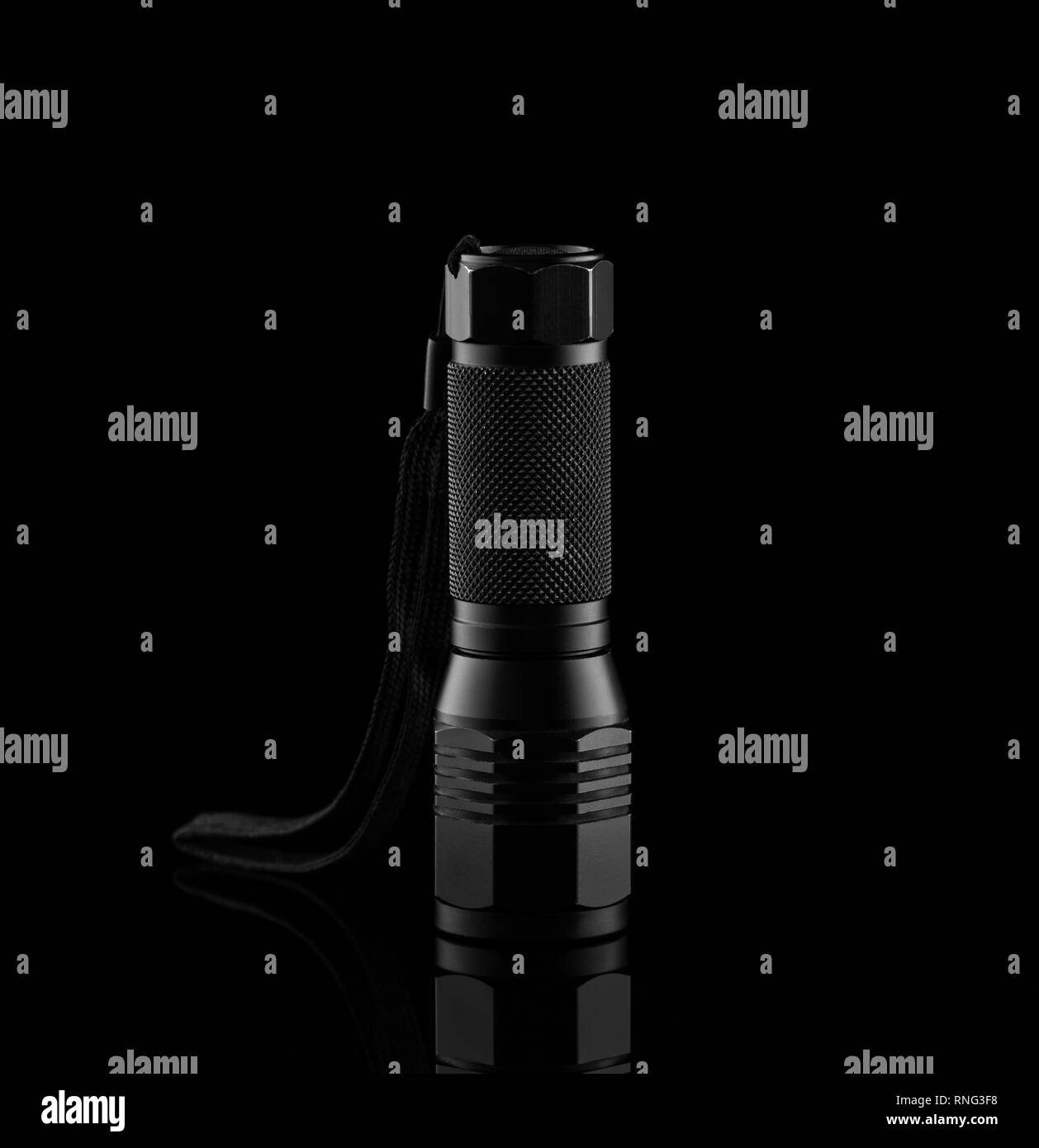 Black metallic flashlight on a dark background Stock Photo Alamy