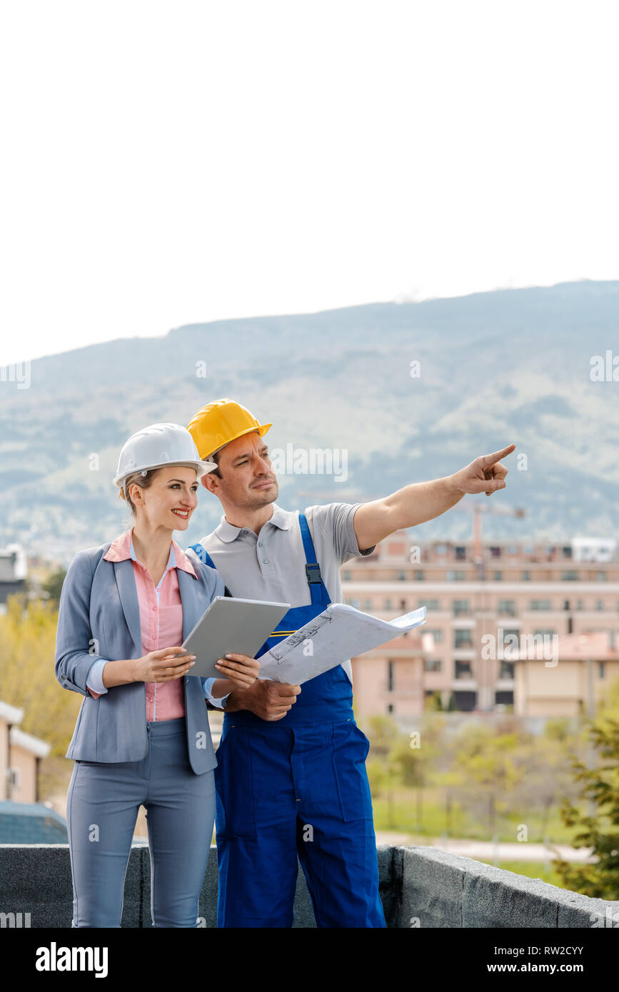 Architect and builder developing ideas for construction project Stock