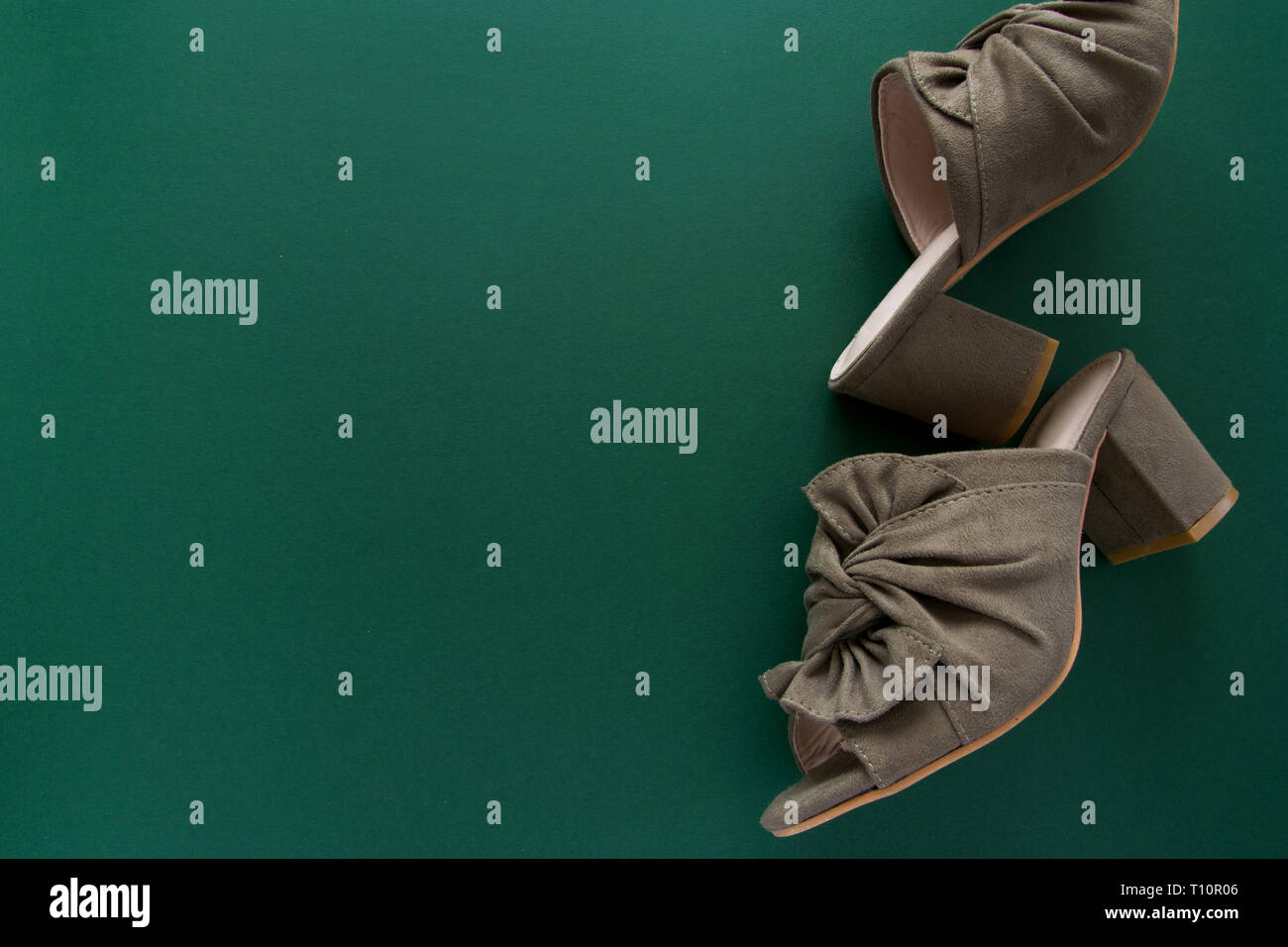 Pair of mules/clogs (military green color) on deep green background