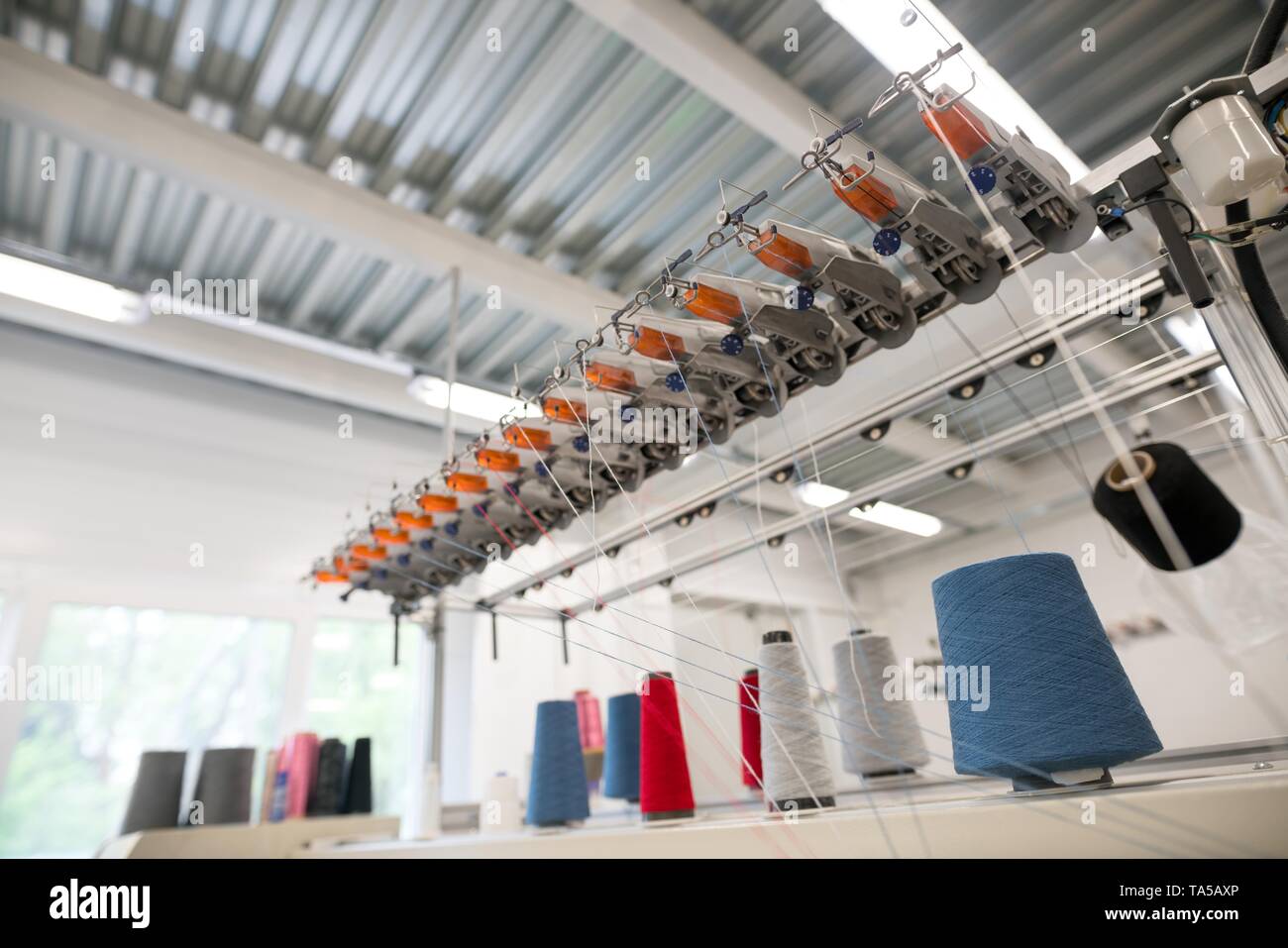 Sewing thread bobbin on machine Stock Photo - Alamy
