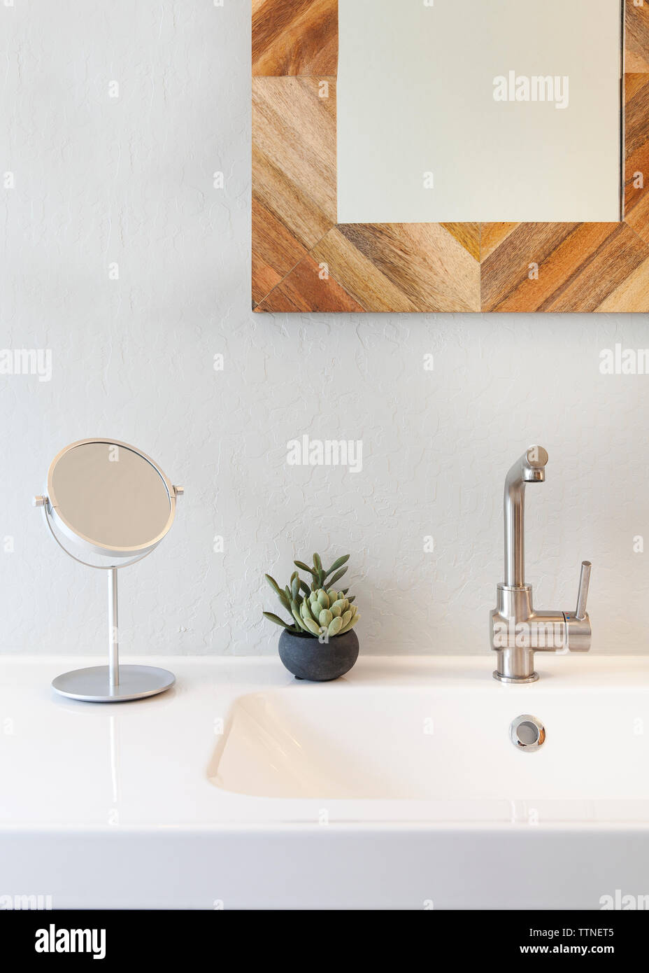 Mirror over sink against white wall Stock Photo Alamy
