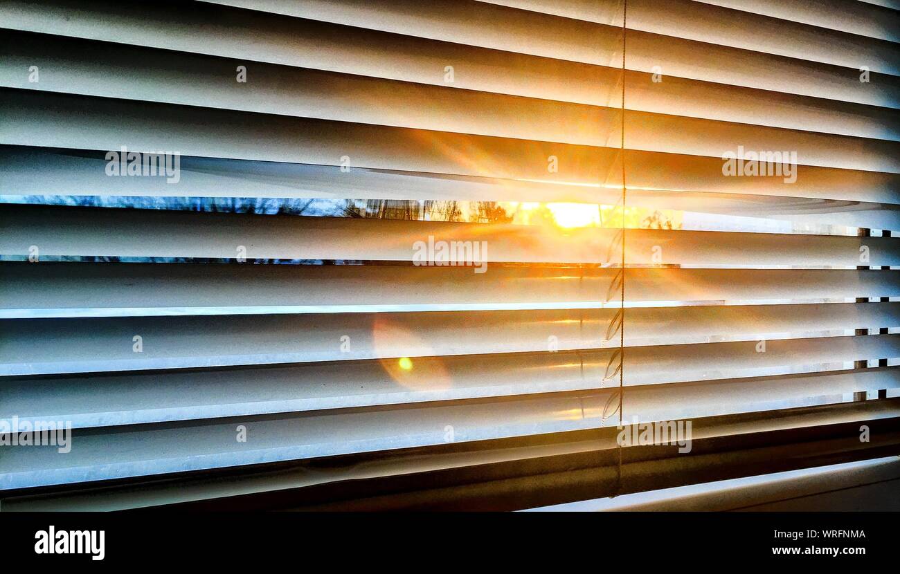 Sunlight streaming through blinds hires stock photography and images