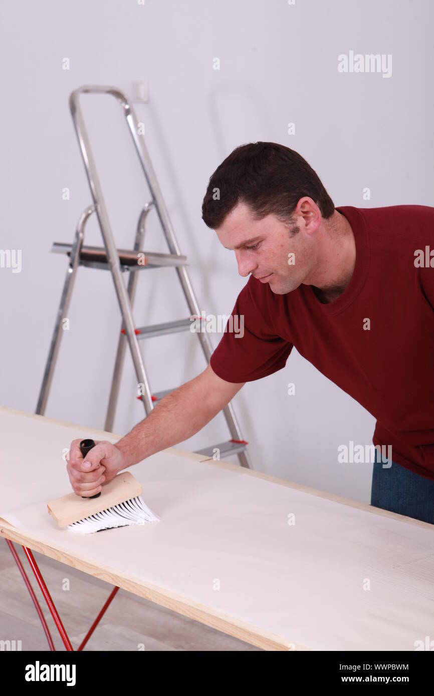 Man pasting wallpaper Stock Photo Alamy