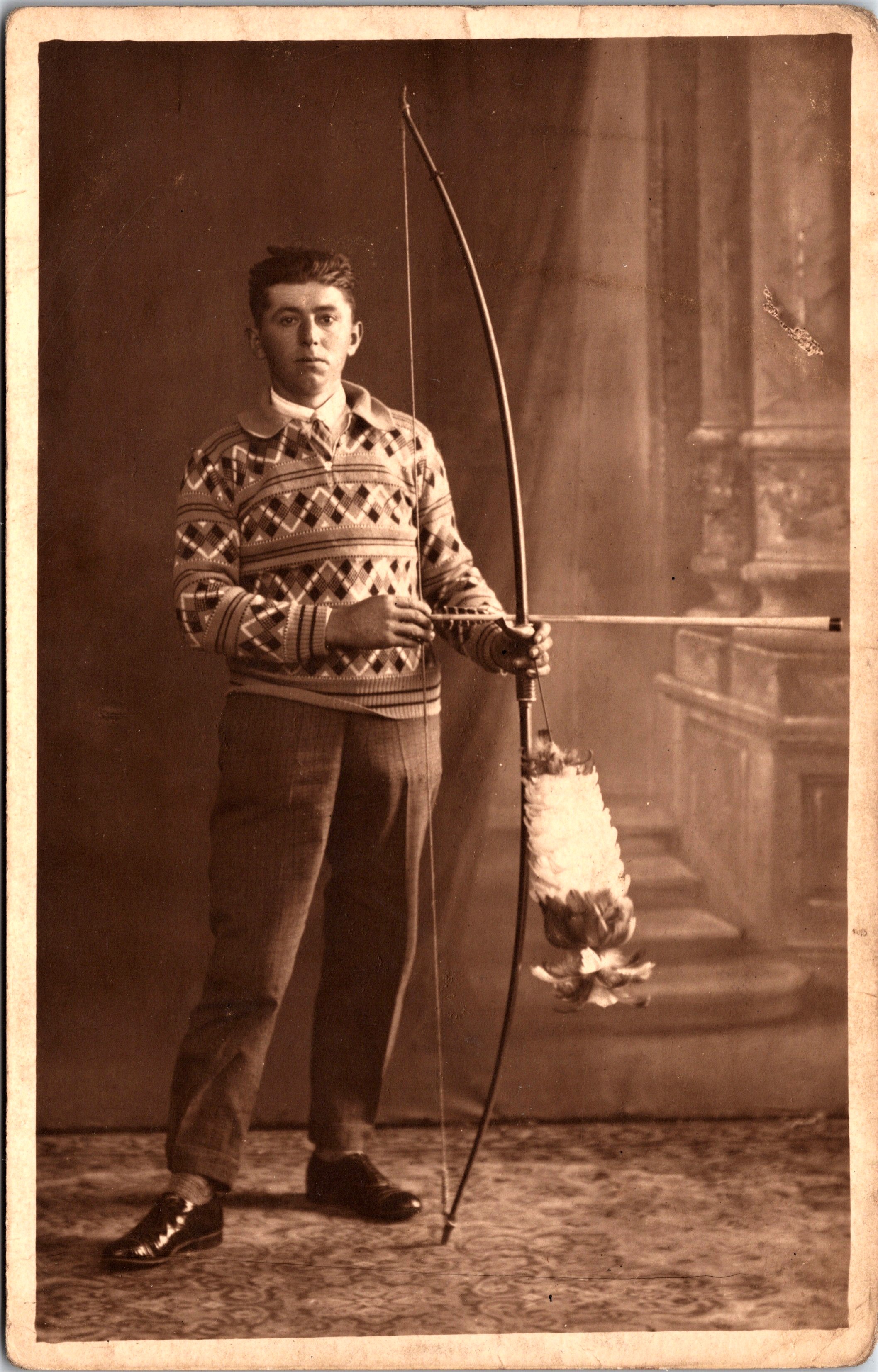 PORTRAIT OF A YOUNG ARCHER AND HIS SERIOUS BOW AND ARROW (NATIVE