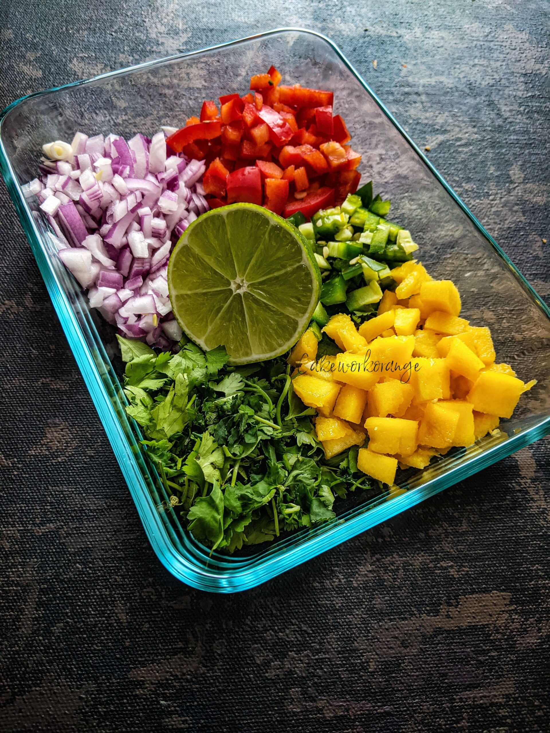 Ingredients used to make mango salsa assembled in a bowl. 