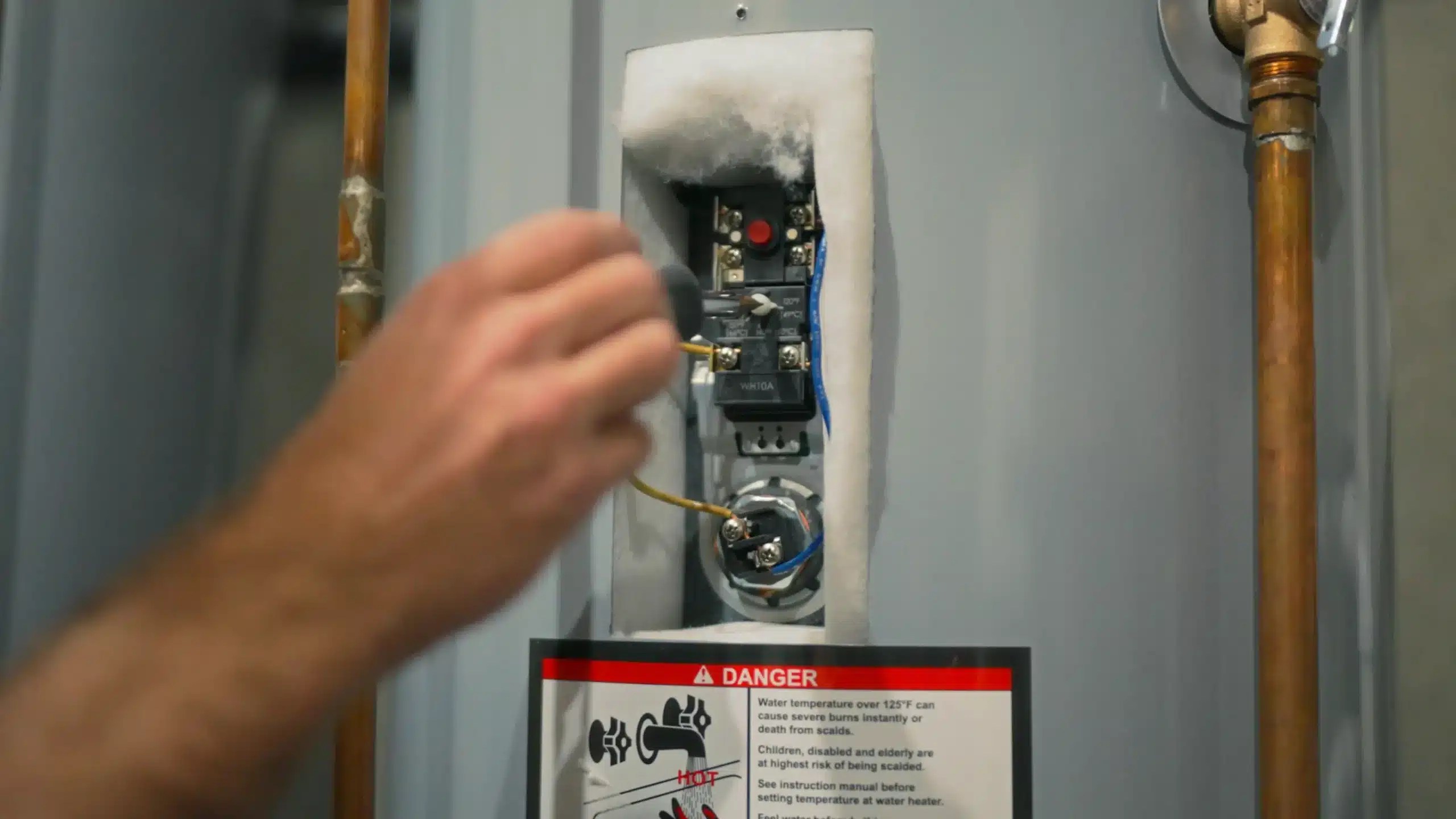 How do I adjust water temperature on my electric water heater