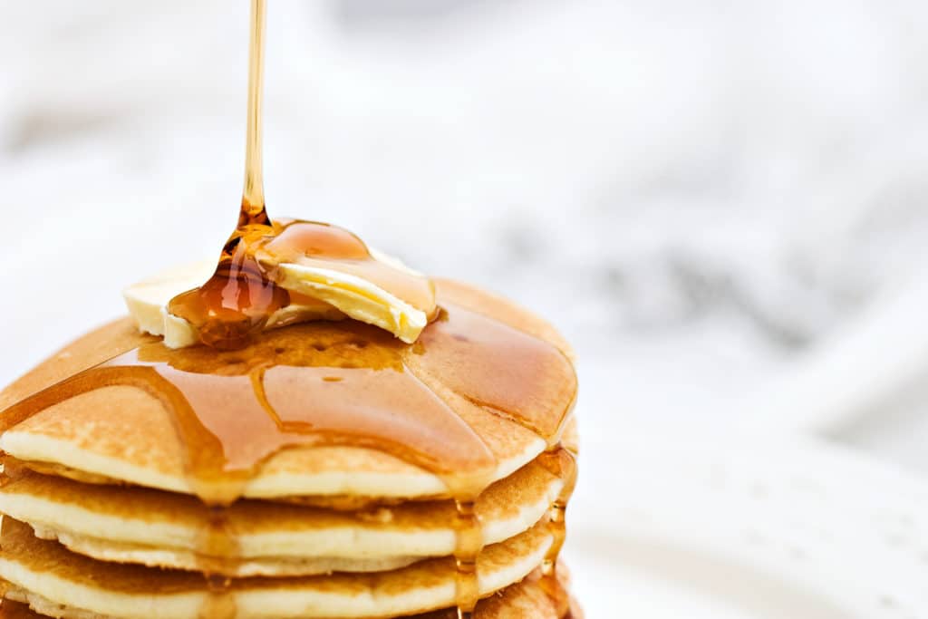 Maple syrup pouring onto pancakes. Calorie Control Council