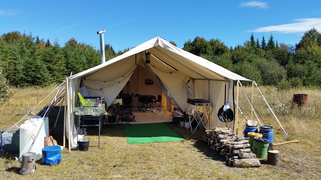 Canvas wall tent used for cooking meals and as a dining room Canoe