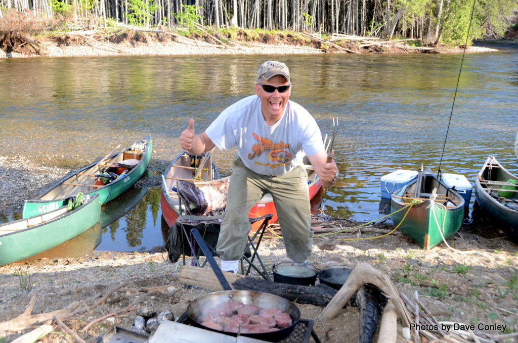 Cooking steaks on Cascapedia River canoe trip Canoe the Wild