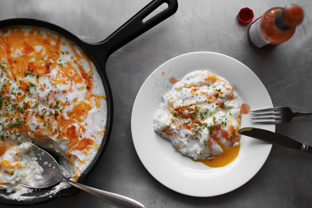 eggs poached in grits, shakshukastyle Cardamom and Tea