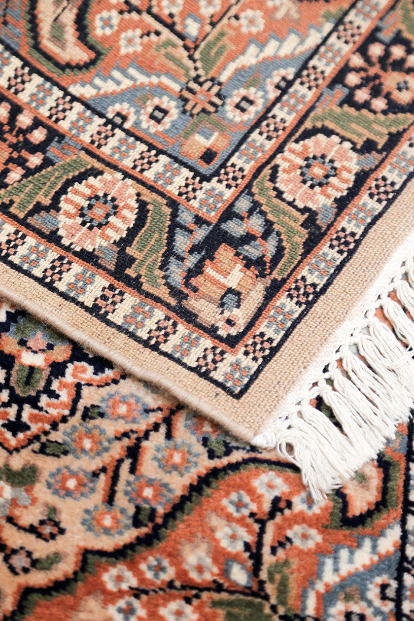 Hand knotted bedside rug with floral design handmade from Carpets of