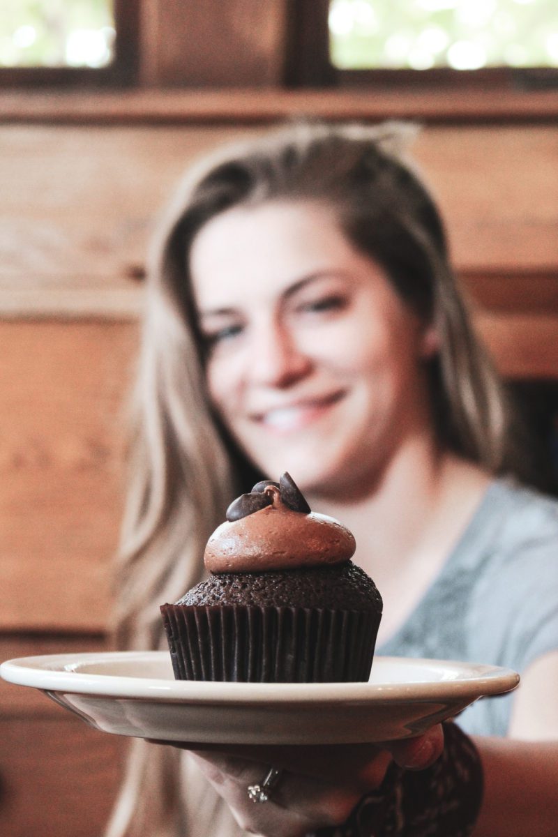 girl holding cupcake