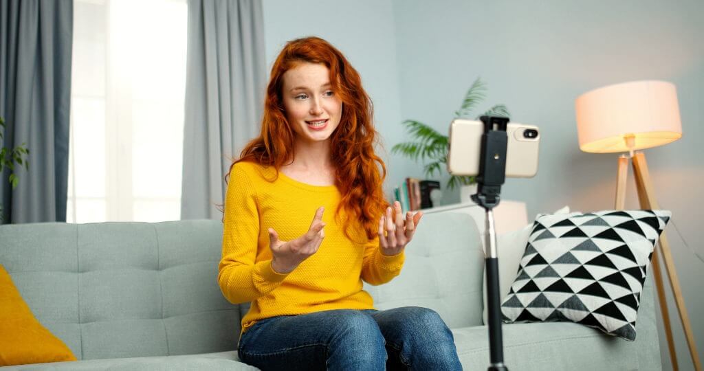 Portrait,Of,Young,Female,Blogger,Sitting,On,Couch,And,Talking Casting