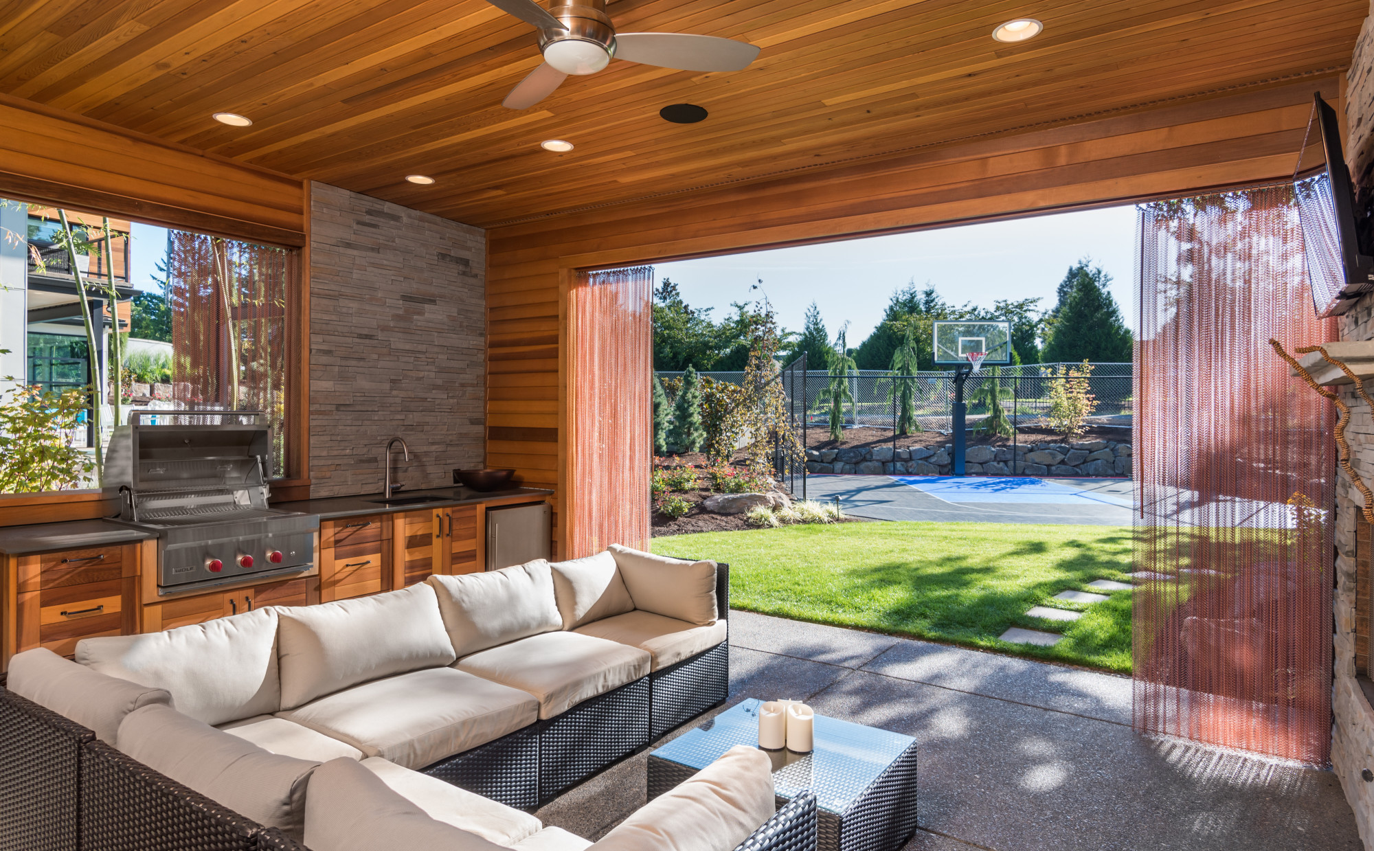 Beautiful covered patio outside new luxury home with television