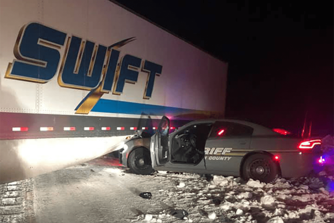 Firefighters teach truck drivers how to chain up after icy crash caught
