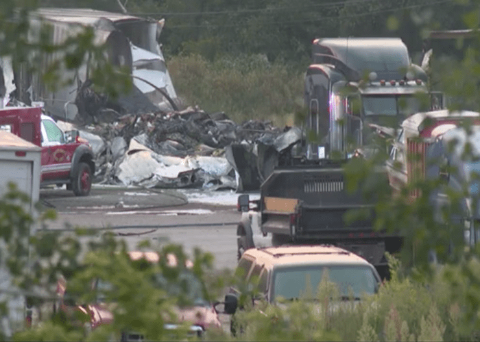 Cargo plane crashes into semis at truck repair shop, two killed