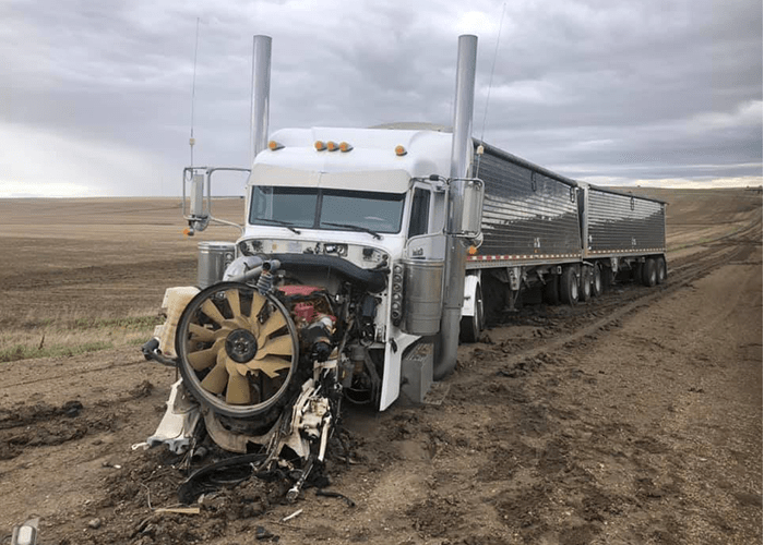 Using farm equipment to rescue a stuck semi goes spectacularly awry