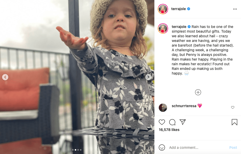 Terra Jolé's Daughter Penny Plays in the Rain Wearing a Grey Floral
