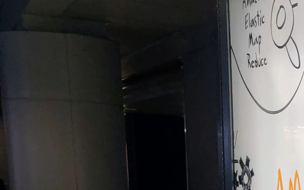 Professional working on AWS cloud dashboard with multiple monitors showing cloud architecture and data analytics