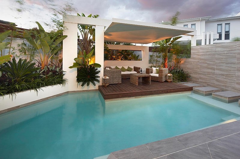 Custom Pool Area undercover patio lounge with garden beds and palms Custom Pool Area undercover patio lounge with garden beds and palms