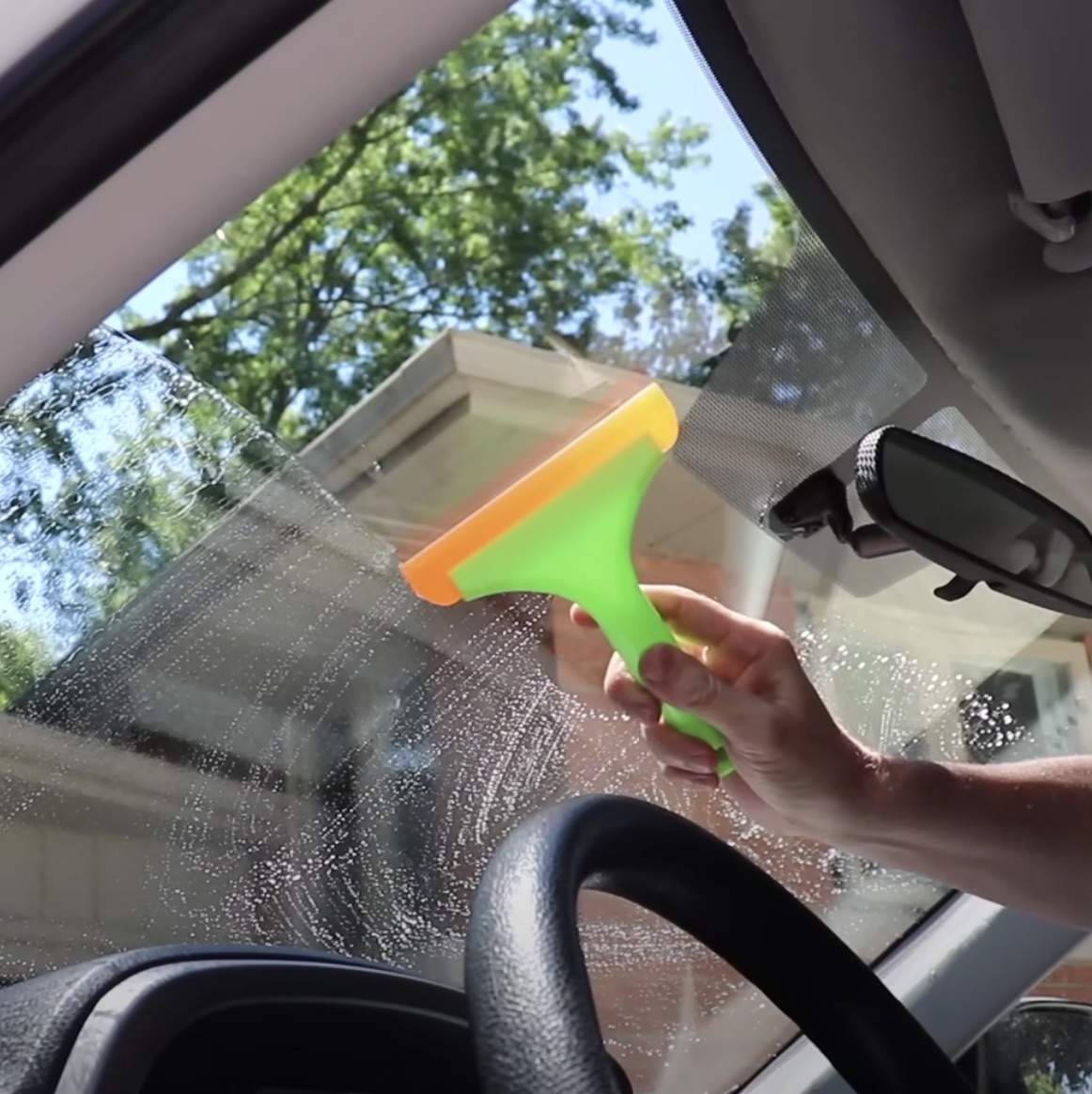 Guy demonstrates easy method to get inside of windshield squeaky clean
