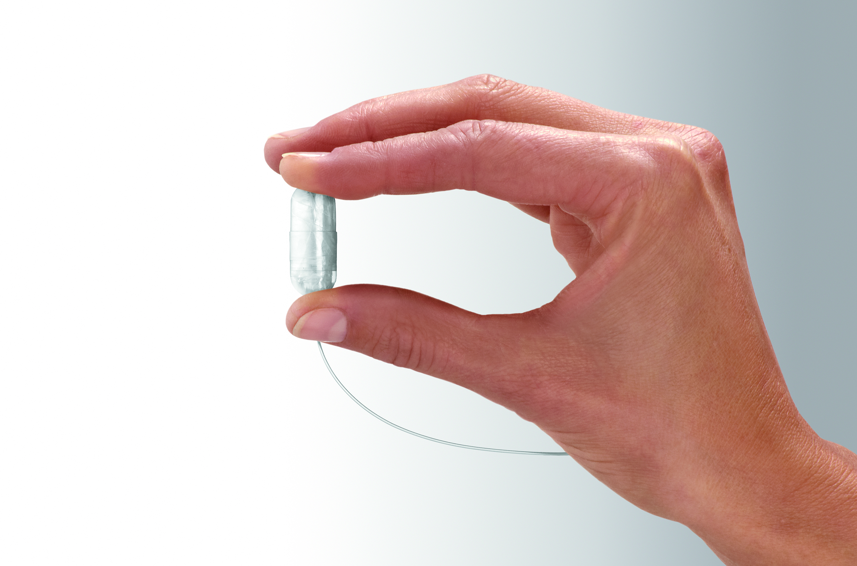 A capsule containing a balloon.