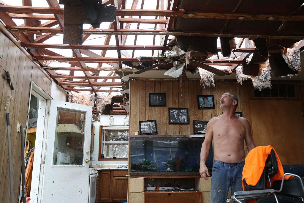 Aaron Tobias, who said he lost everything, stands in what is left of his home after Hurricane Harvey blew in and destroyed most of the house on Aug. 26, 2017, in Rockport, Texas.