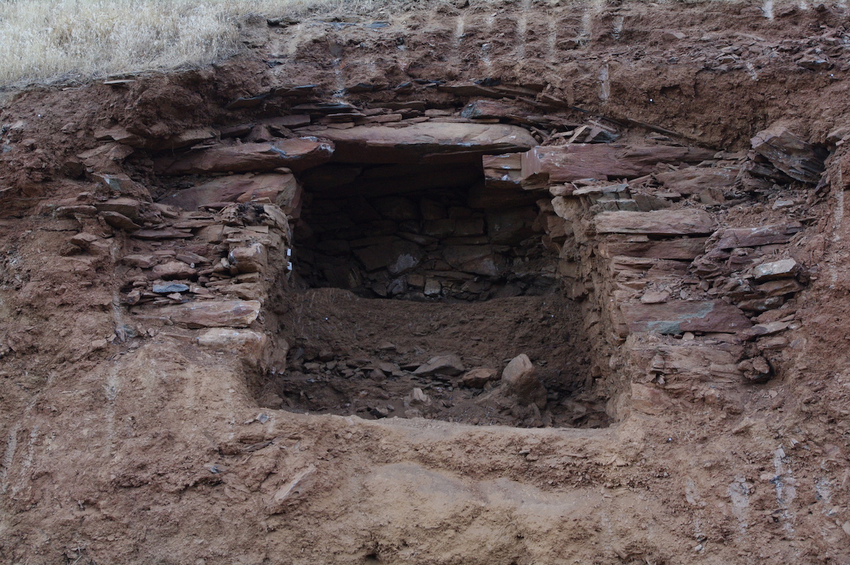 A tomb in northern Iraq held a pile of skeletons, including those dating back 2,400 years and more recent burials (shown here). The white dust is from the excavation of the more recent burials.