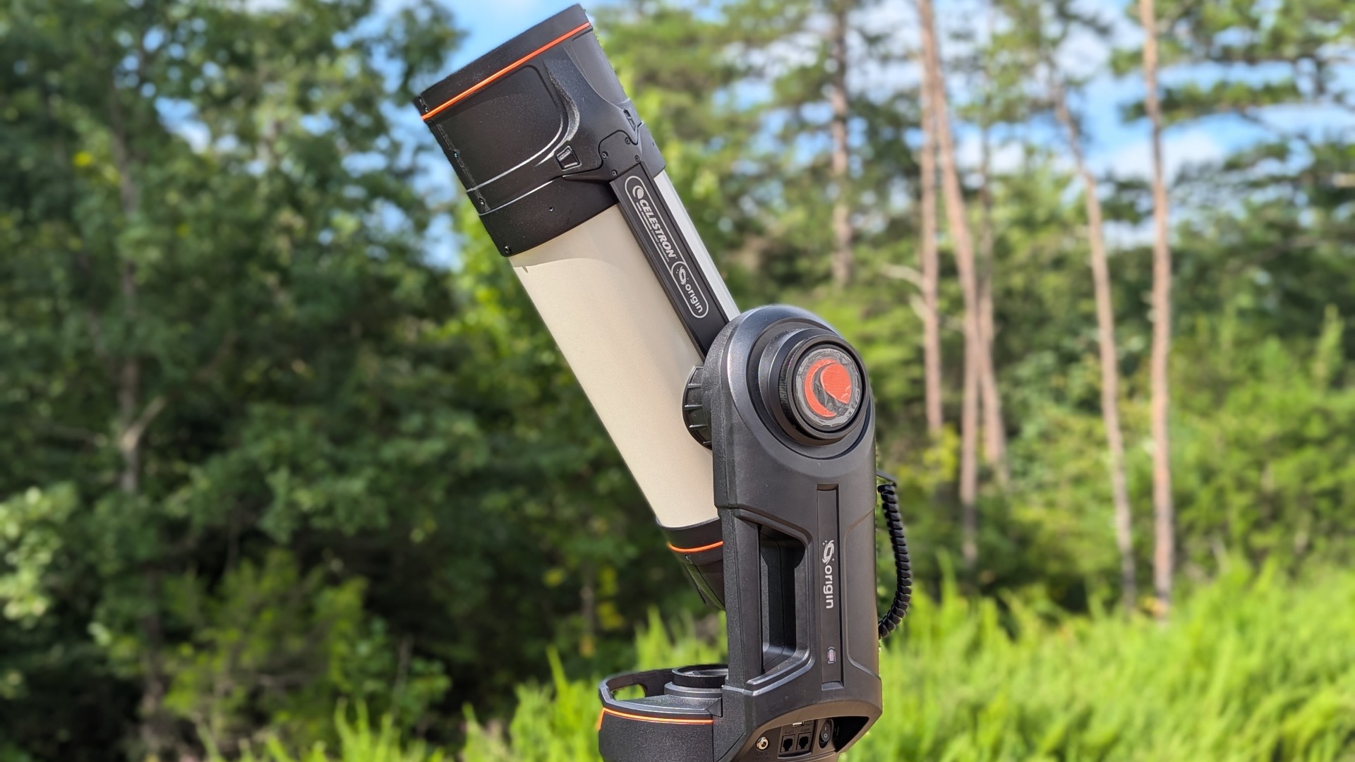 Side view of the Celestron Origin with a forest in the background.