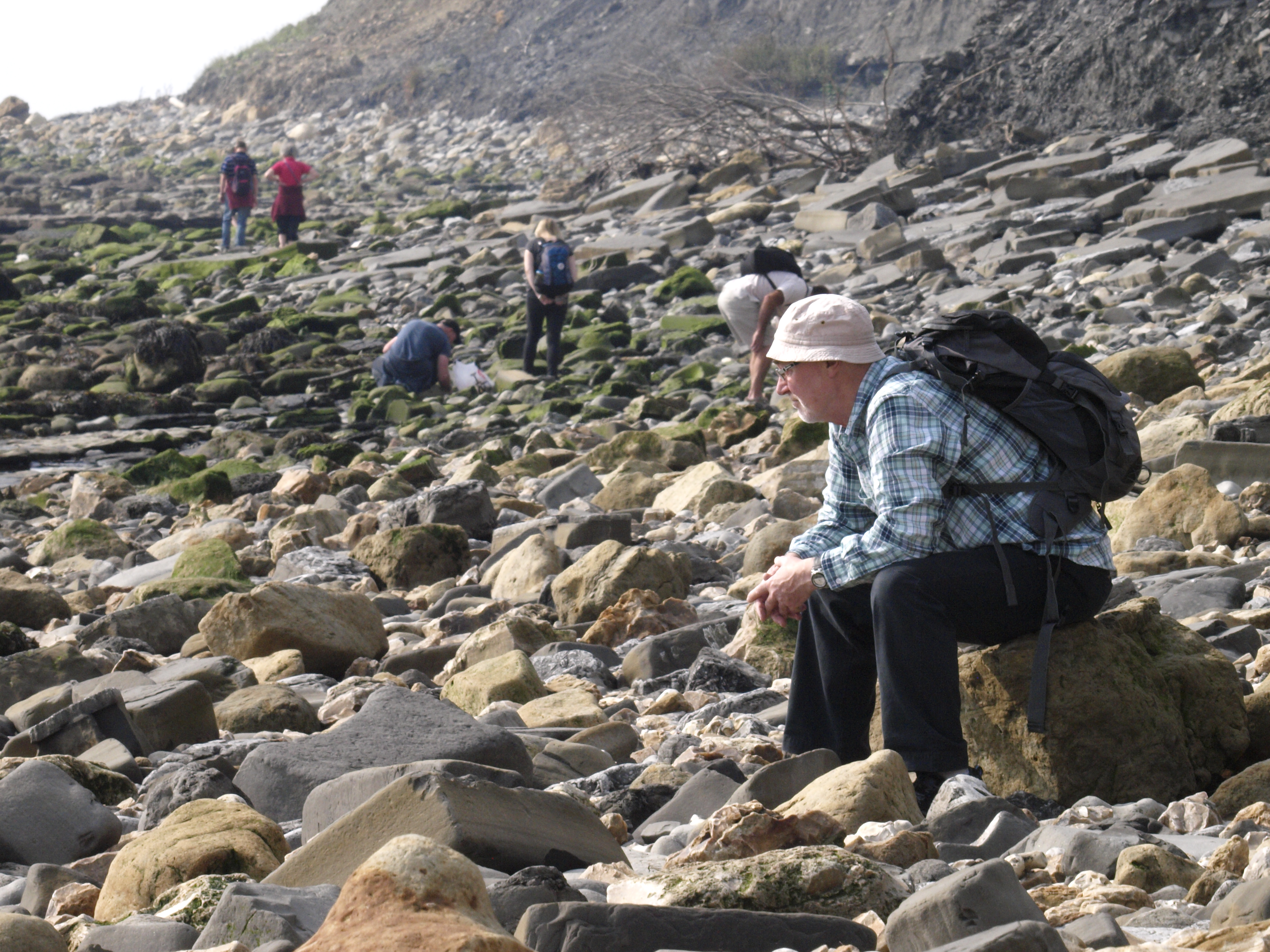 Fossil hunters on a beach at Lyme Regis, where Mary Anning made her discoveries and sold fossils.