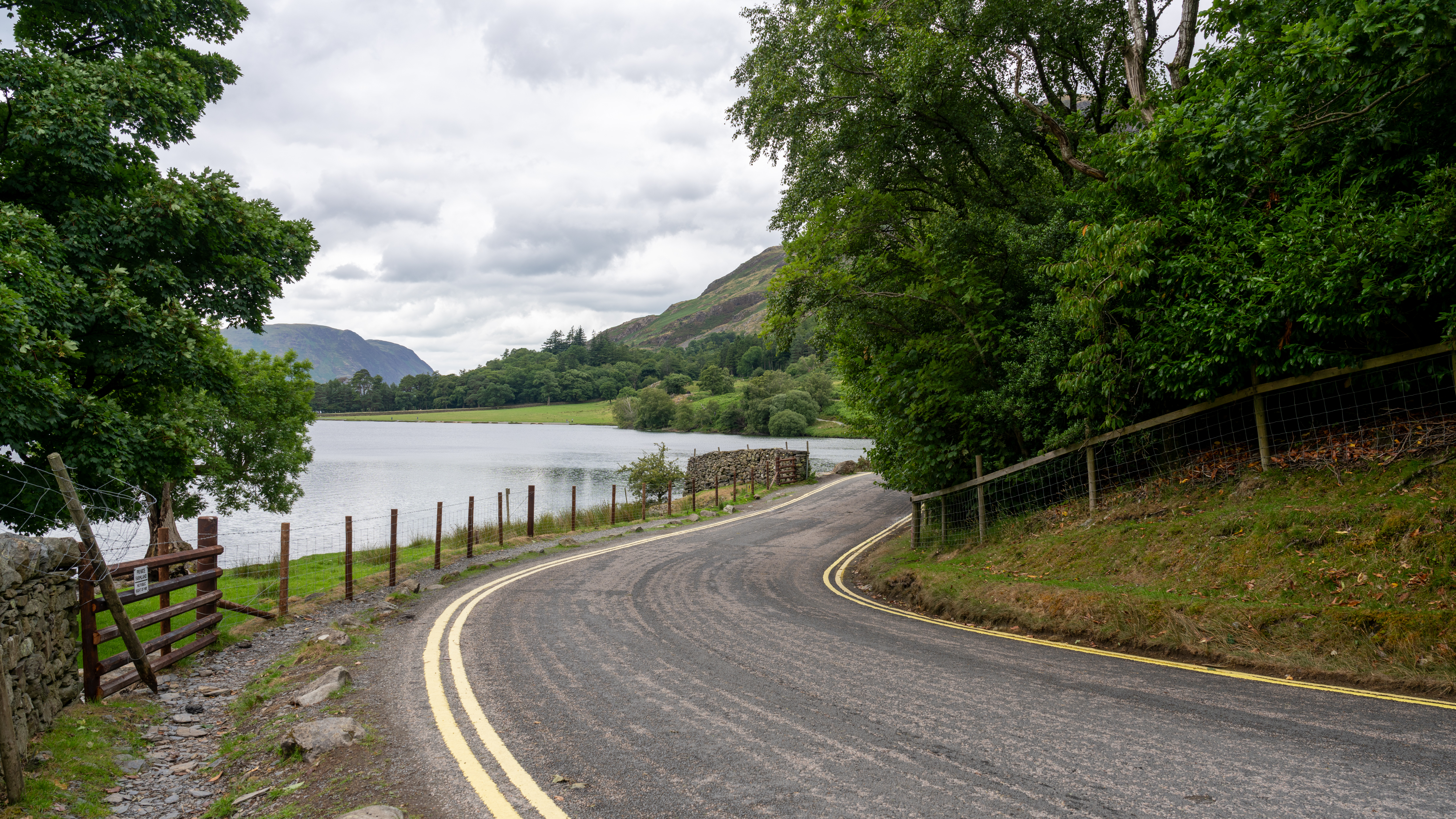 a lakeside road on an overcast day