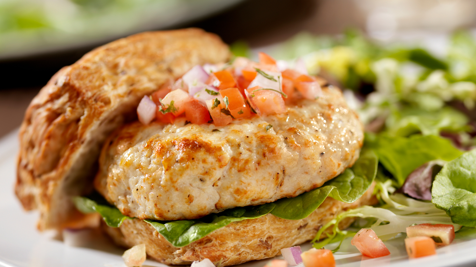 turkey burger on a wholewheat bun with tomato and lettuce