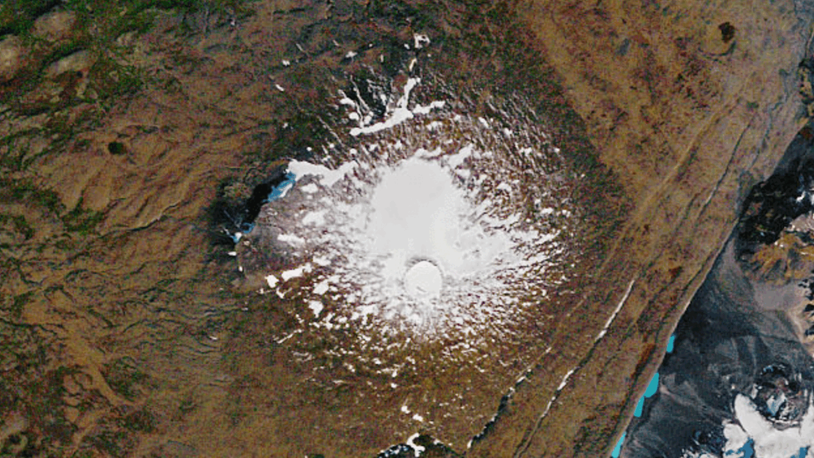A GIF showing before and after satellite pictures of a glacier disappearing from a mountain�s summit