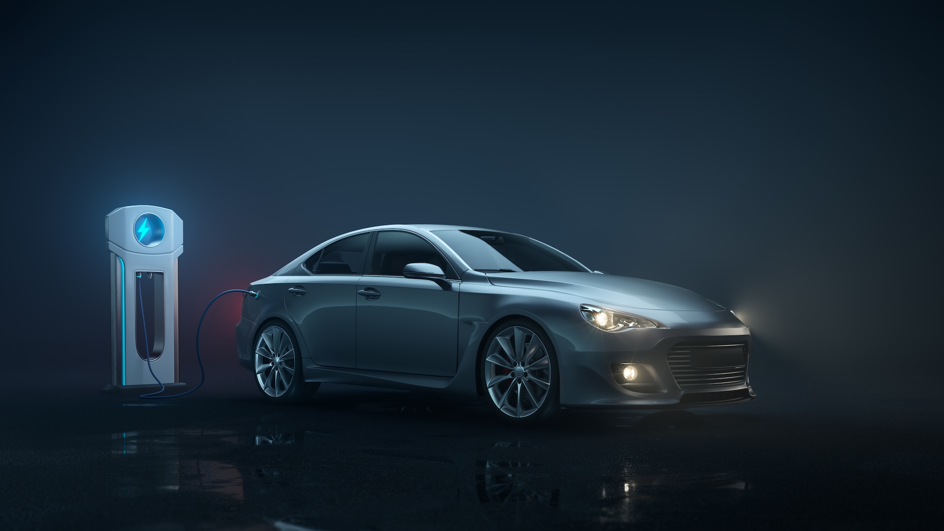 Electric car being charged at charging station.