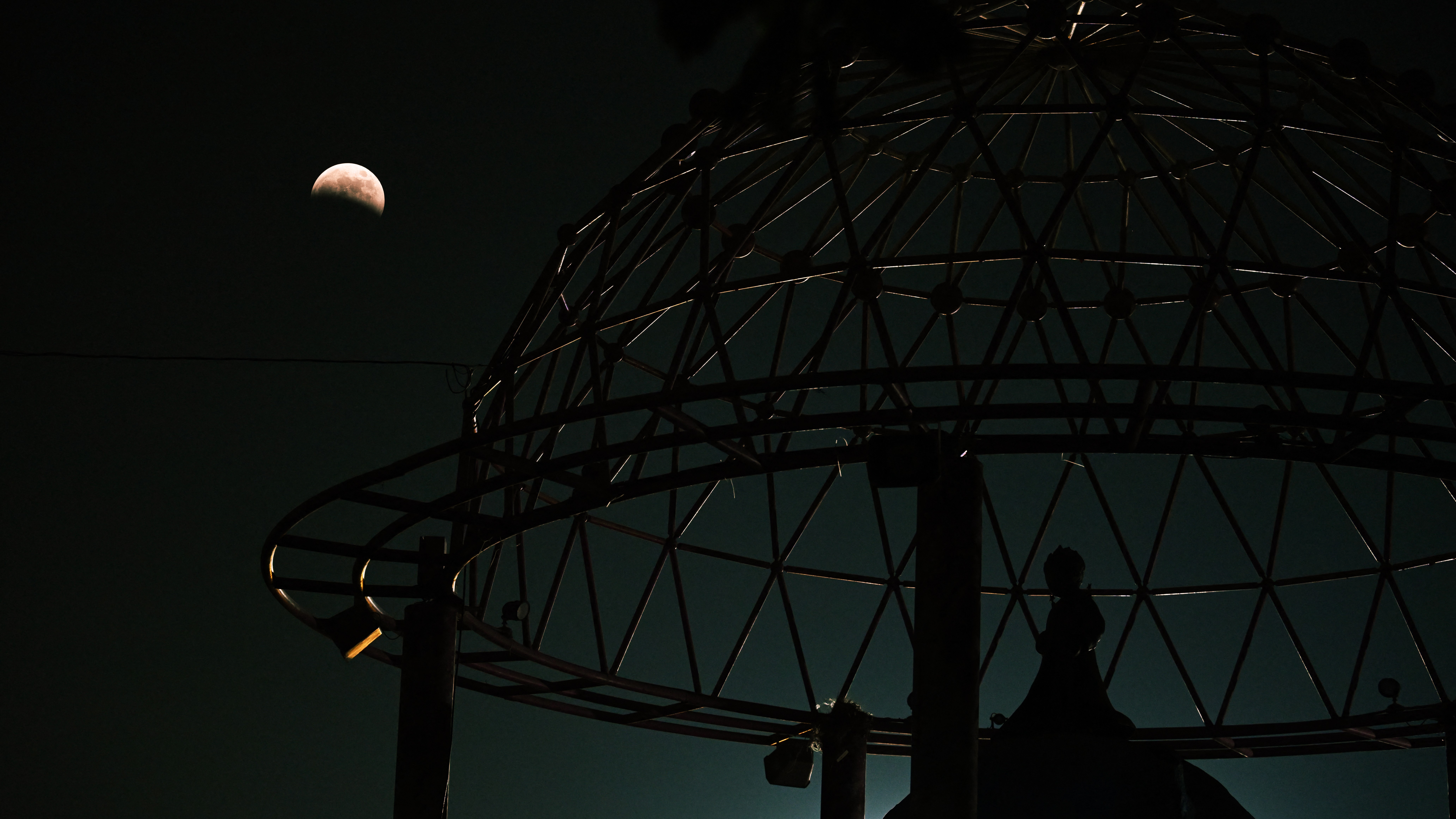 A photo of the &lsquo;blood moon&rsquo; above the Little Prince monument in San Salvador, El Salvador.