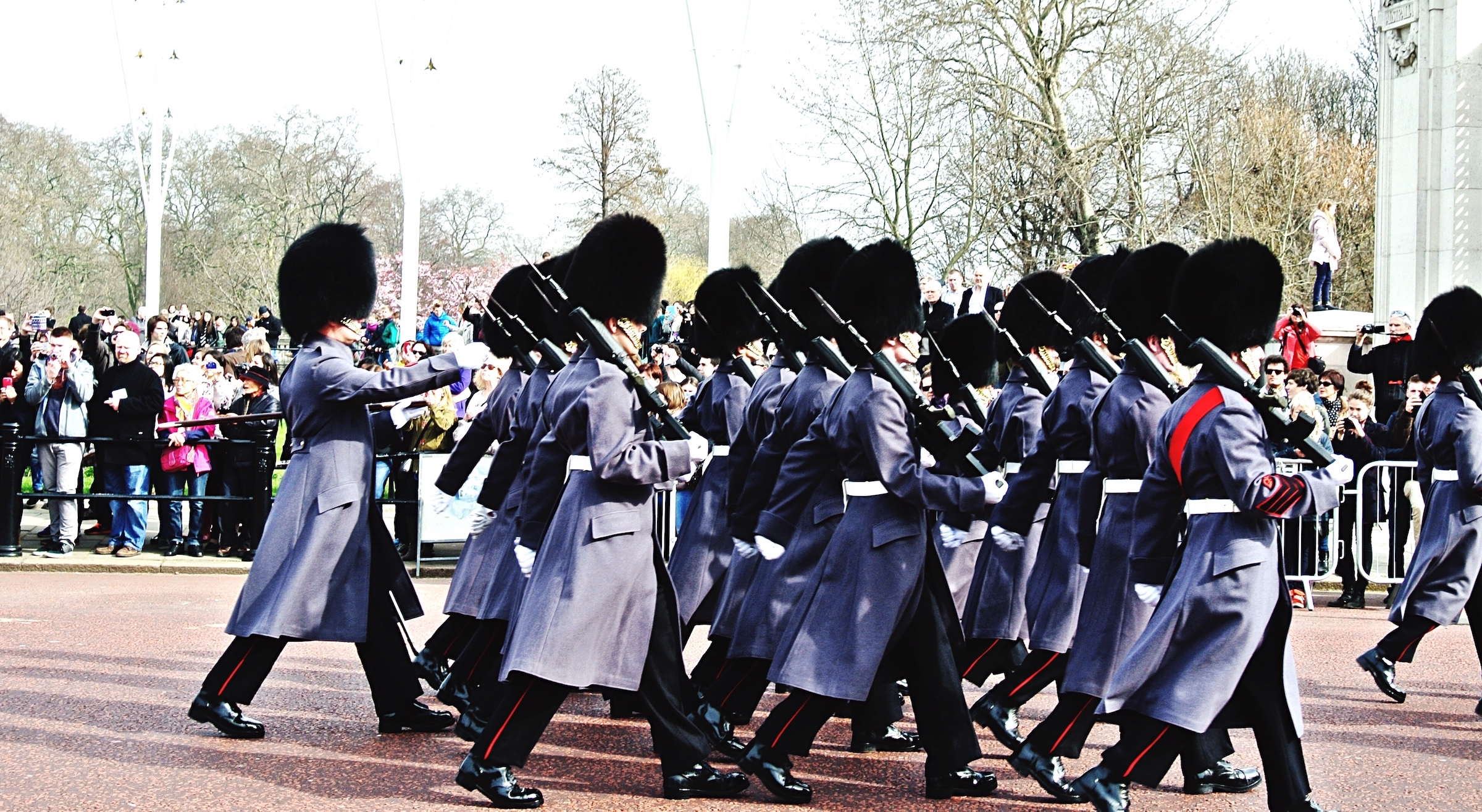The Honor Guard marches on parade in gray coats.