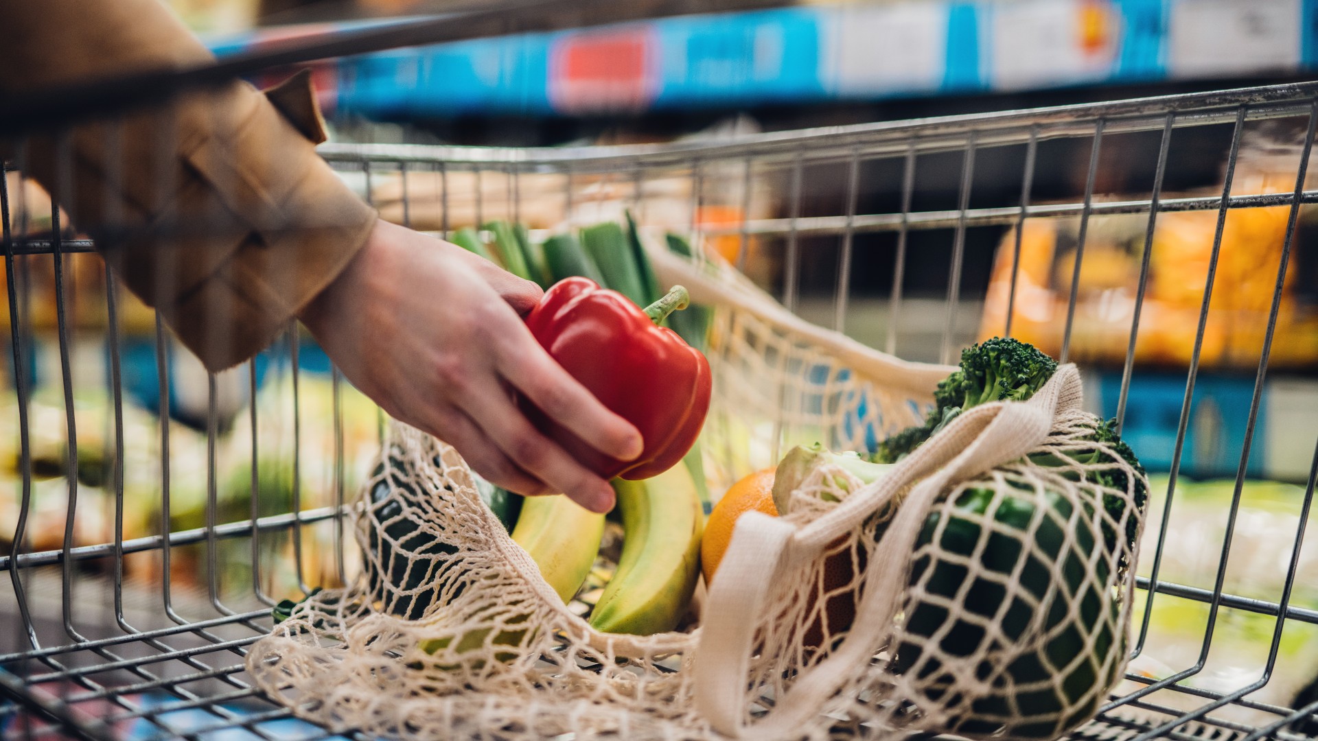 Vegetables being put in grocery cart