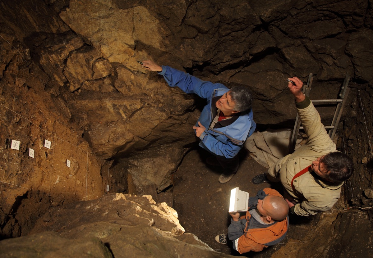 Scientists found DNA related to the extinct human lineage called Denisovans in Denisova Cave in Siberia. Here, Richard (Bert) Roberts, Vladimir Ulianov and Maxim Kozlikin (clockwise from top) plan the sampling of sediments in the cave�s east chamber.