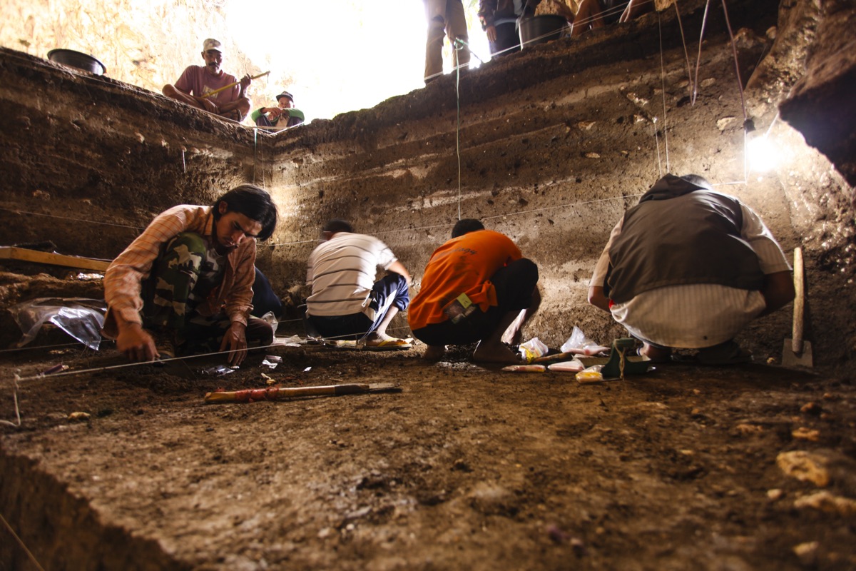 Archaeologists excavate sediment deposits dating to the Holocene (the last 11,700 years of Earth&rsquo;s history) in the Liang Bua cave.