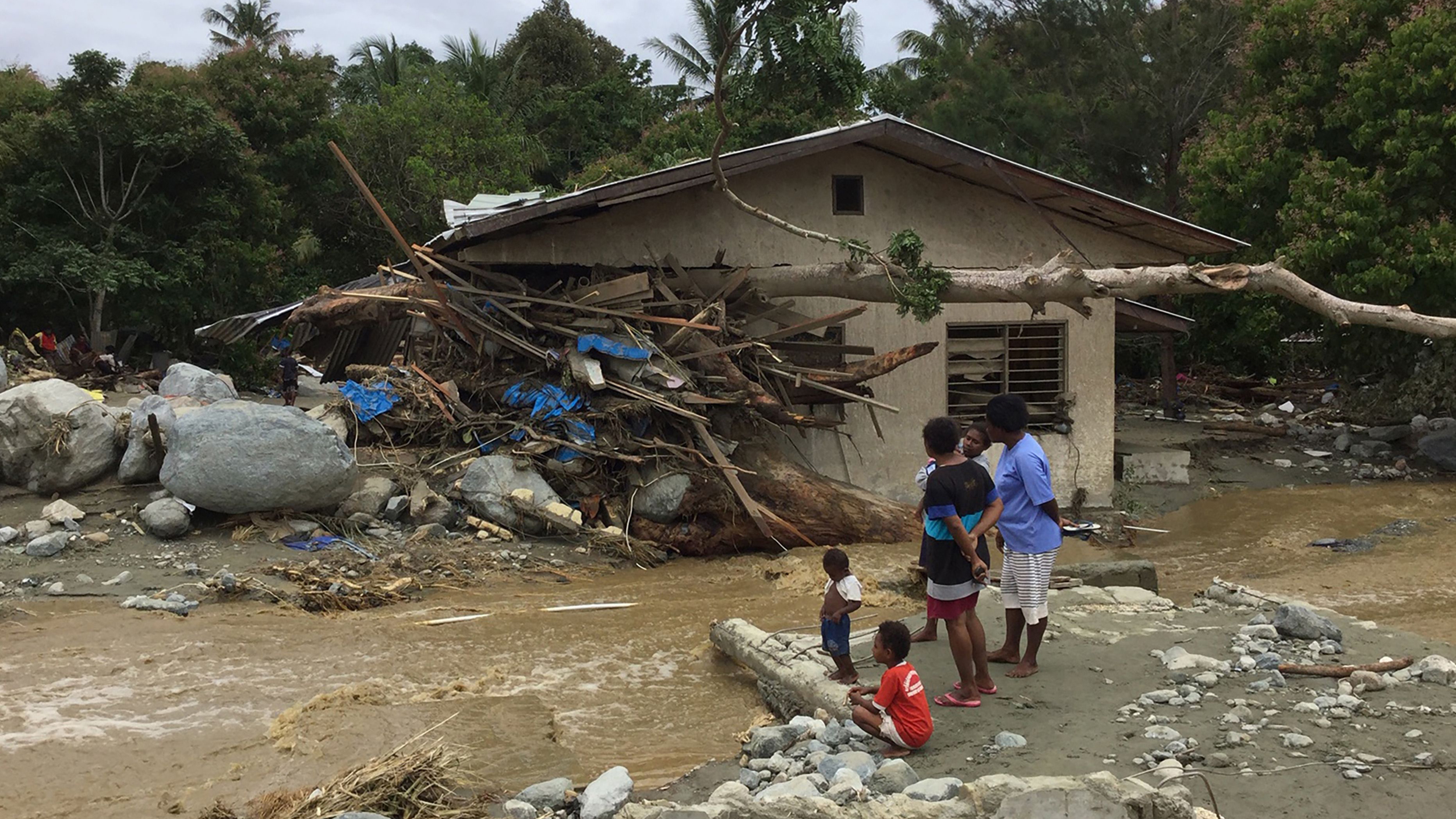 Tree trunks and debris washed away by flash floods are seen lodged in a damaged house in Sentani near the provincial capital of Jayapura, Indonesia&rsquo;s eastern Papua province, on March 17, 2019.